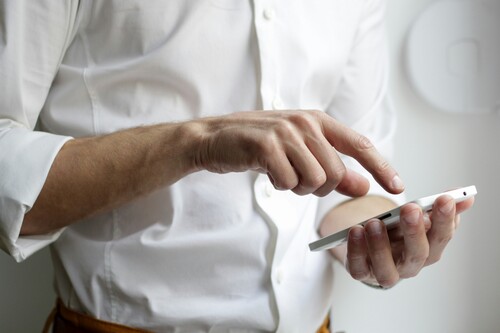 Person using a smartphone at a desk